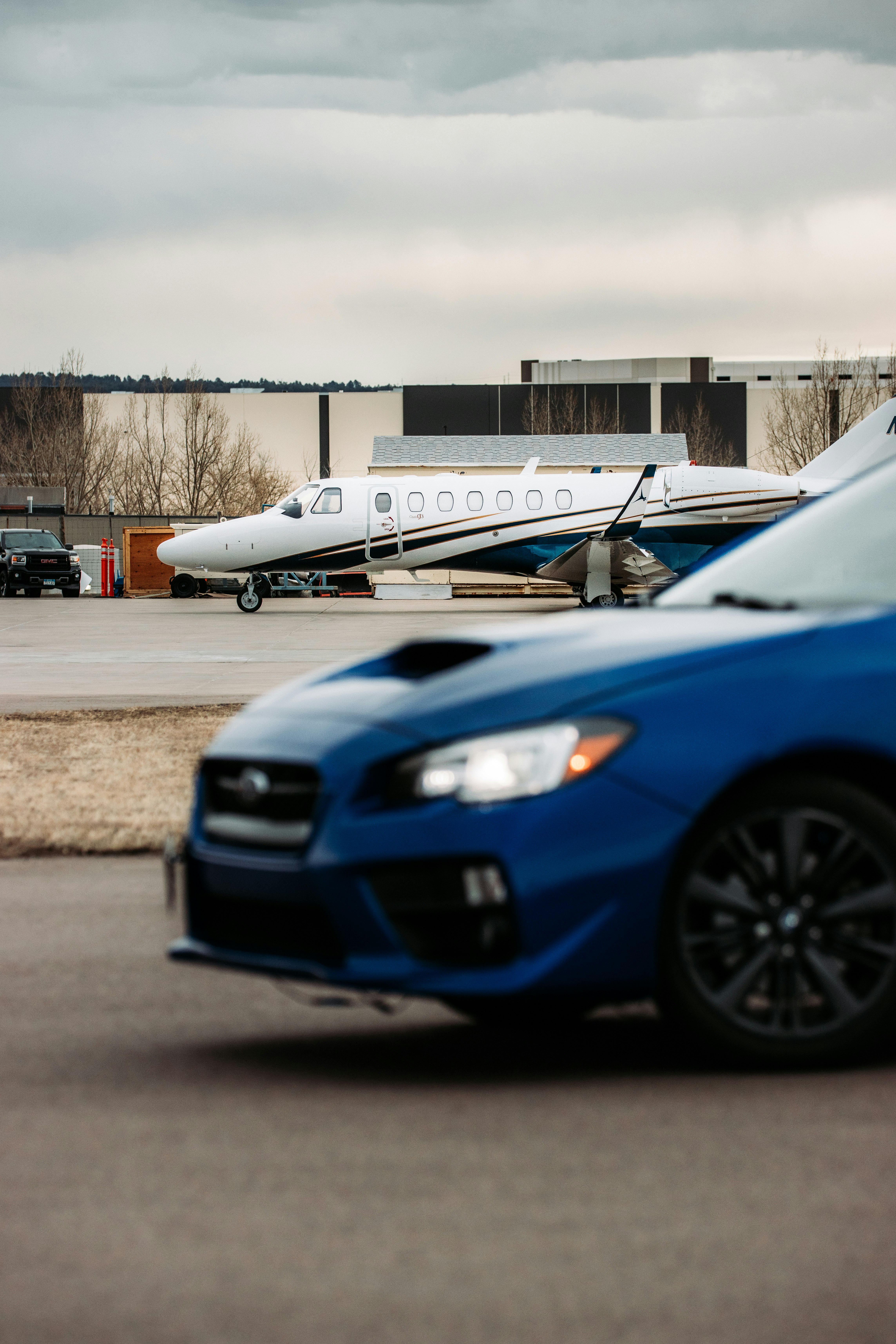 blue and white passenger plane on gray asphalt road during daytime